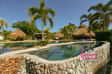 Infinity swimming pool with jacuzzi palapas tropical landscaping at Ensenada Resort San Carlos Panama