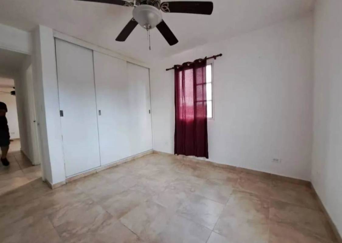 Modern kitchen with breakfast bar, white cabinets, black countertops in Villa Lucre Panama