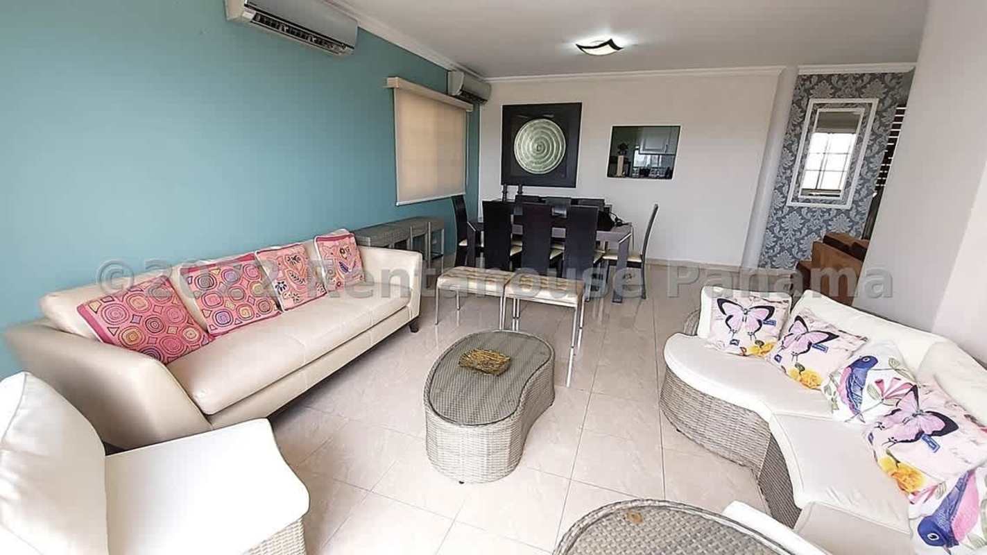 Open dining and living area with natural light, tiled floors and neutral design Betania Panama