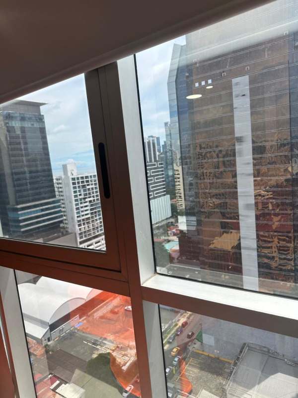 Modern living room with city view windows in PH Obarrio Tower apartment for sale Panama