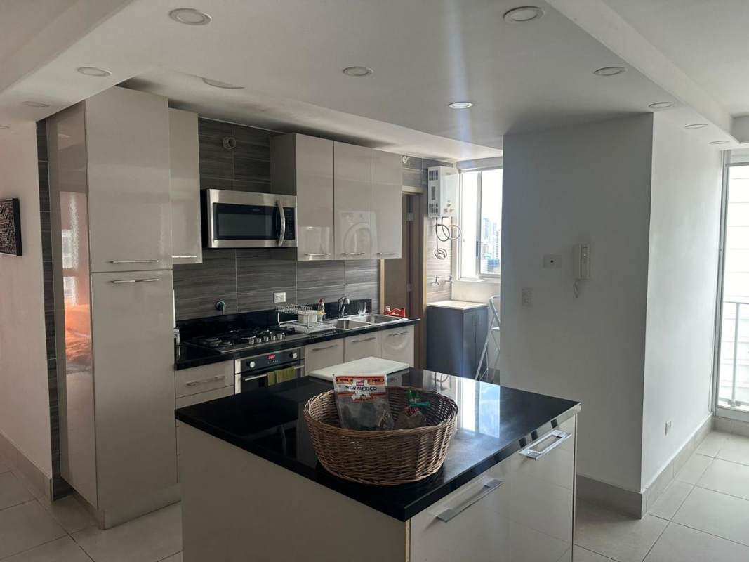 Contemporary kitchen with island granite counter and built-in appliances in apartment for sale Panama City