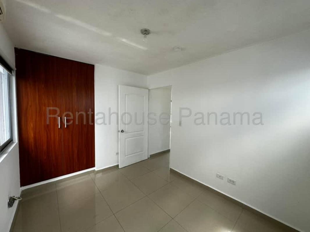 Open plan living room connecting to balcony with panoramic windows in Betania Panama City