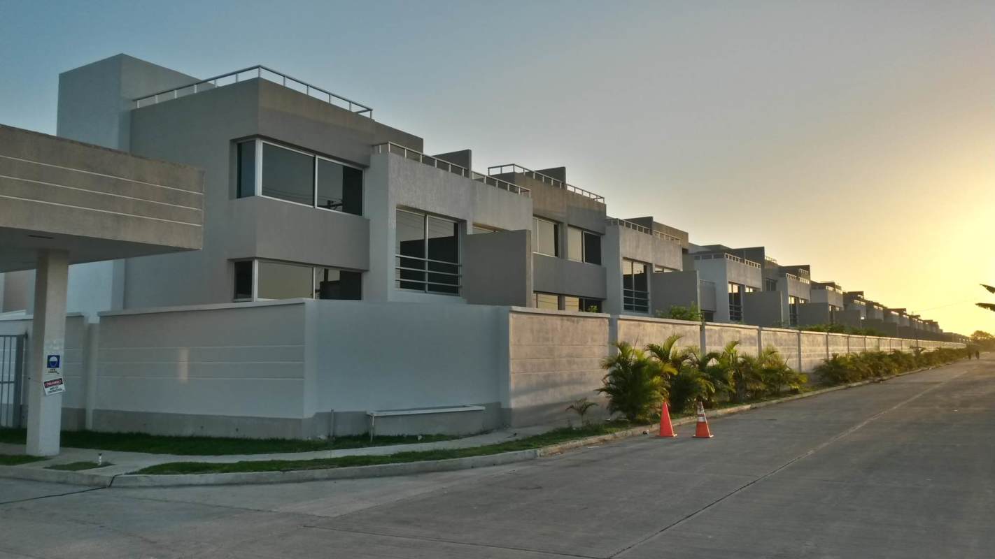 Modern row of townhouses with minimalist design in gated community Costa Sur Village Panama City