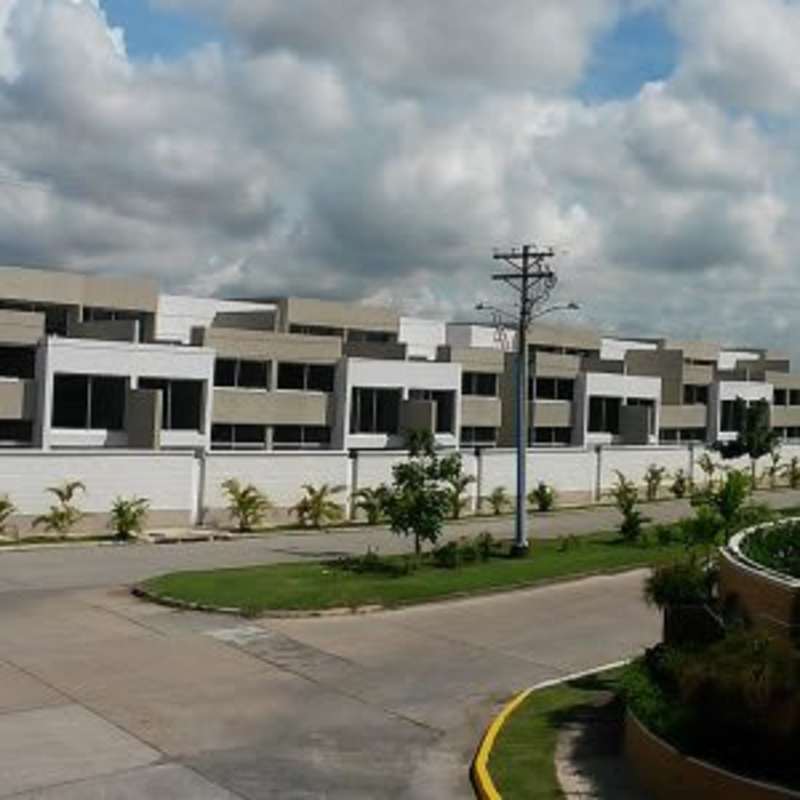 Family-friendly residential community with pool, gardens, and modern townhouse buildings Costa Sur Panama City