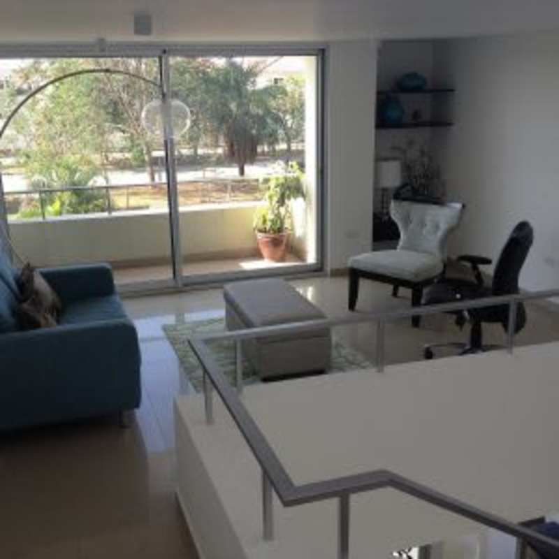 Modern townhouse development with red brick patios, lush lawns, garden views Costa Sur Village Panama