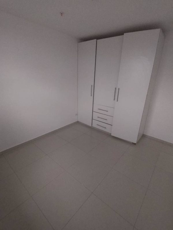Bedroom with white built-in wardrobe, tiled floor, minimalist look Ciudad Radial Panama