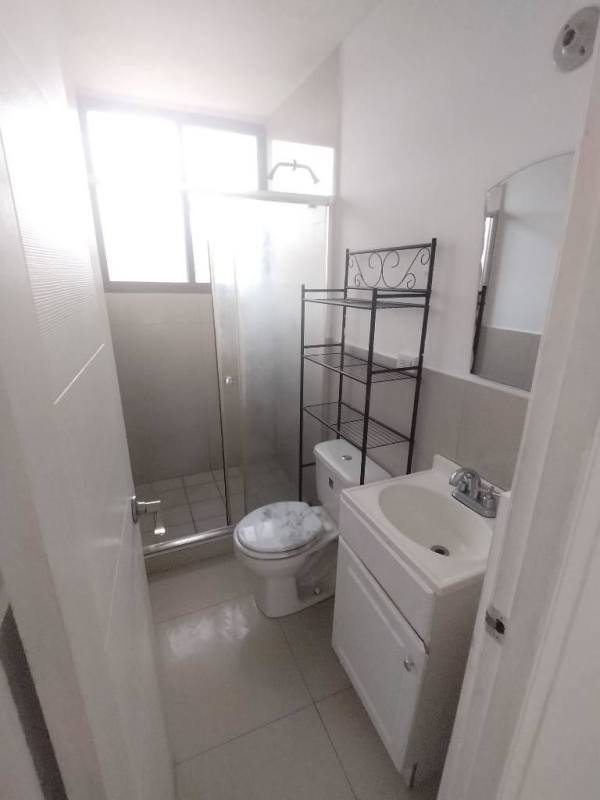 Compact modern bathroom with large mirror, sink, white walls in Ciudad Radial Juan Díaz Panama