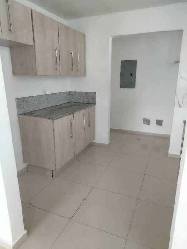 Compact kitchen with granite countertop, light cabinetry, tile floors Ciudad Radial Juan Díaz Panama