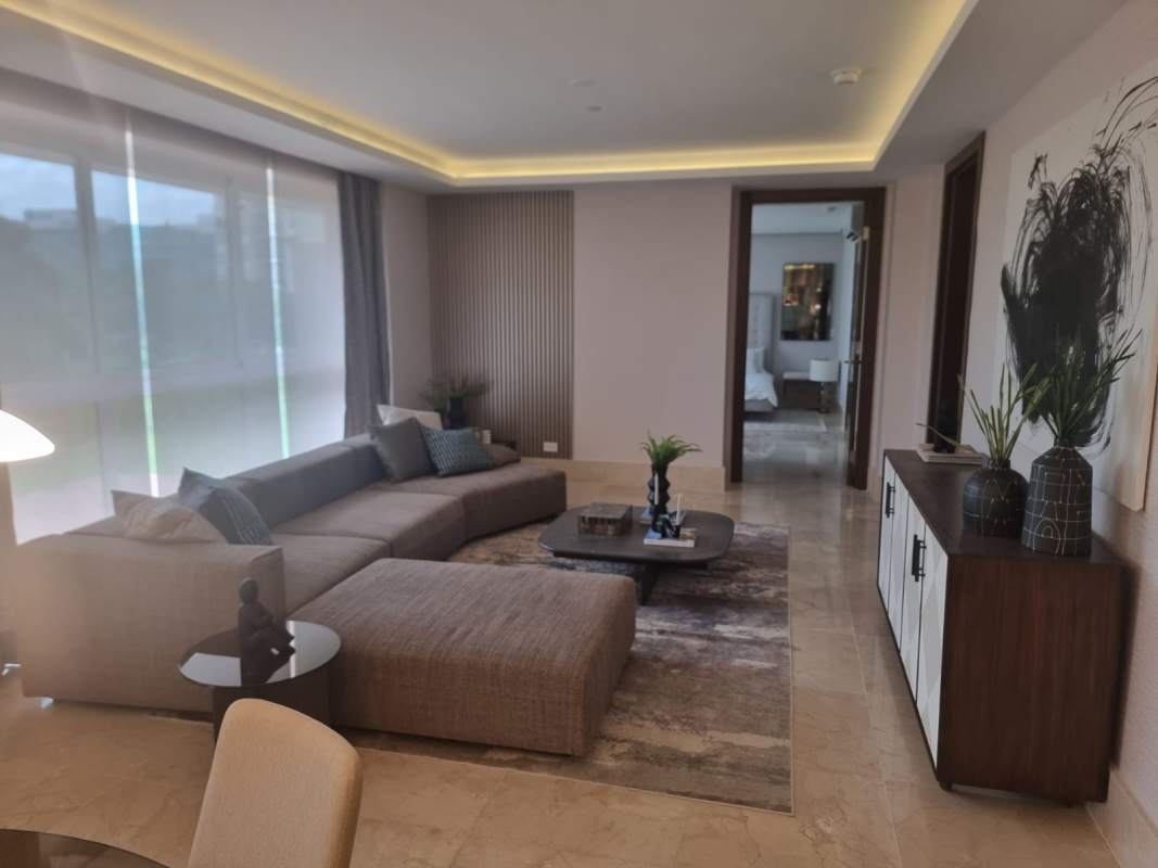 Bright living room with floor-to-ceiling windows, marble floors and golf views in The Reserve Santa Maria