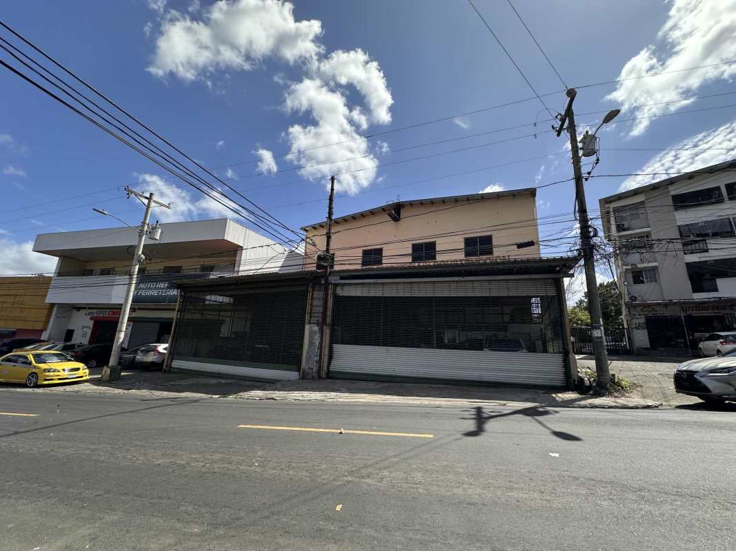 Street view two-story commercial industrial building metal rolling doors Monte Oscuro Panama City