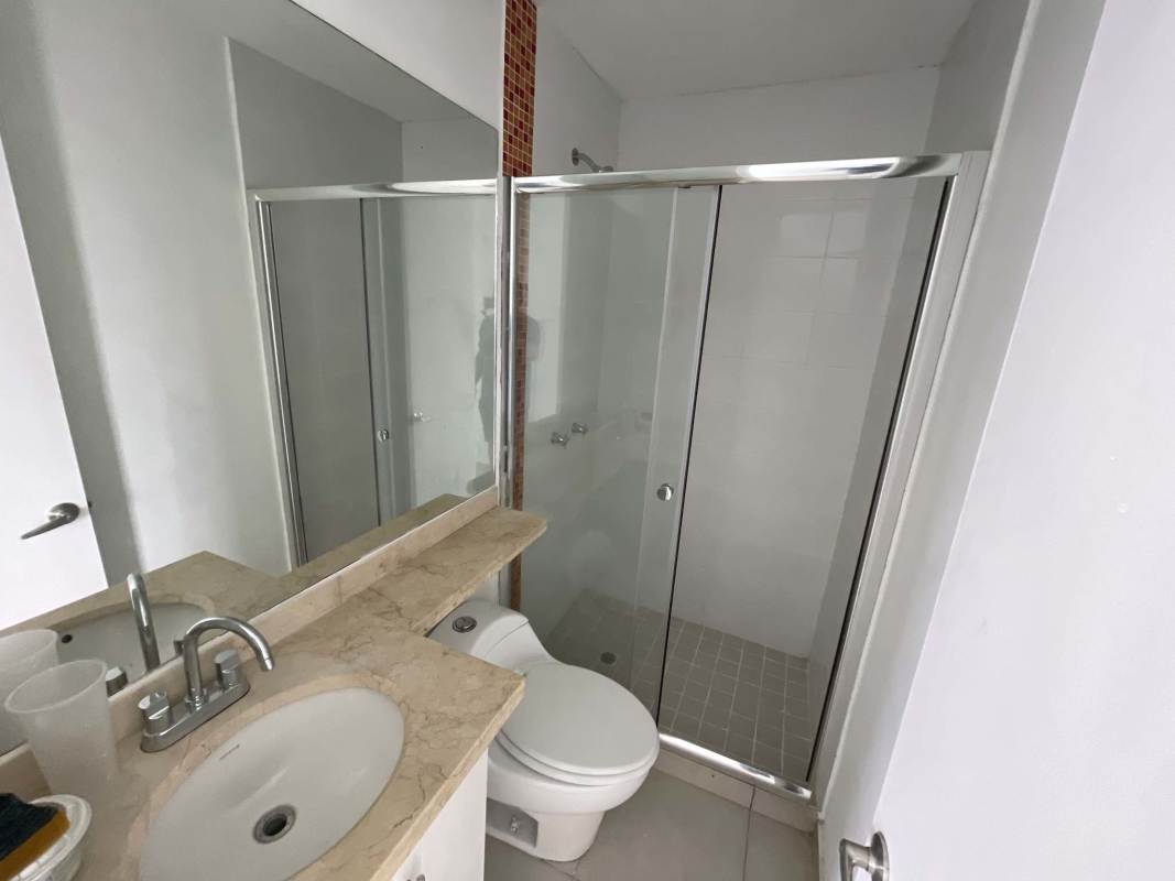 Modern ceramic tiled bathroom with glass shower in PH Alsacia apartment Panama
