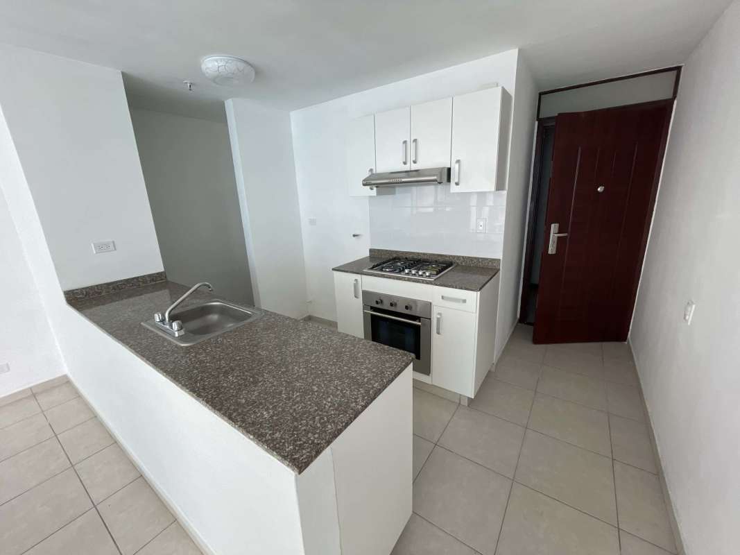 Compact modern kitchen with granite countertop and built-in stove at PH Alsacia Panama