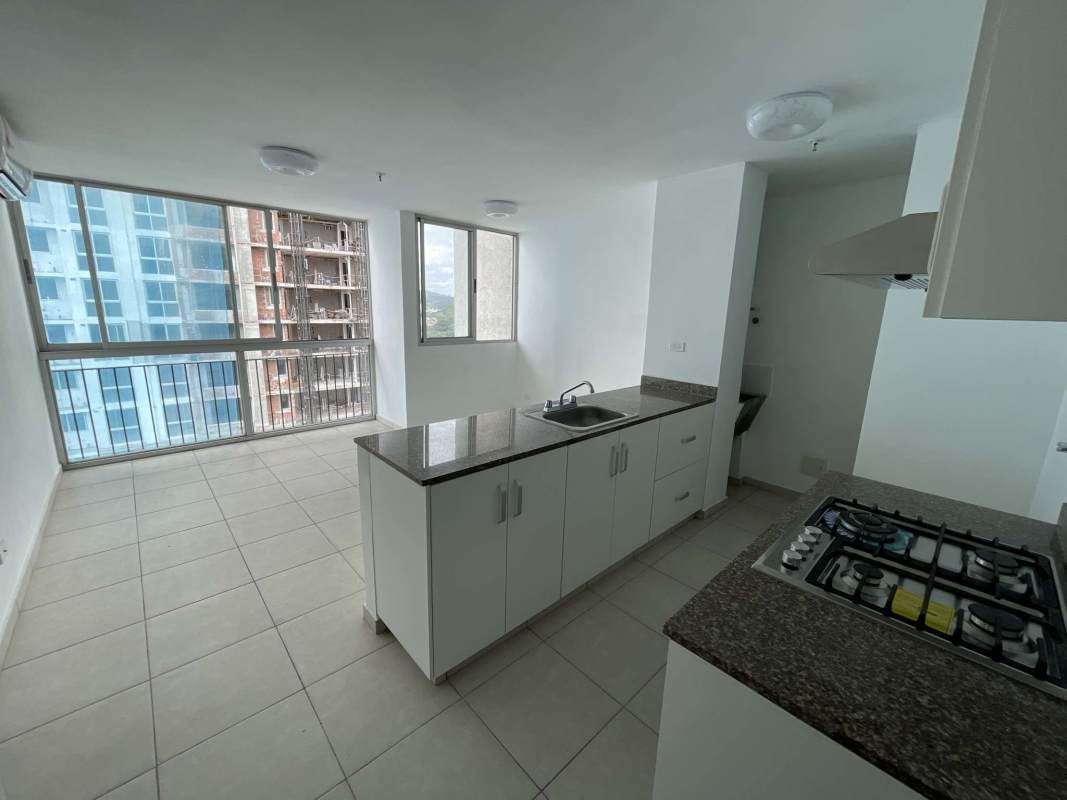 Open plan kitchen with granite countertop and large window in PH Alsacia Condado del Rey Panama