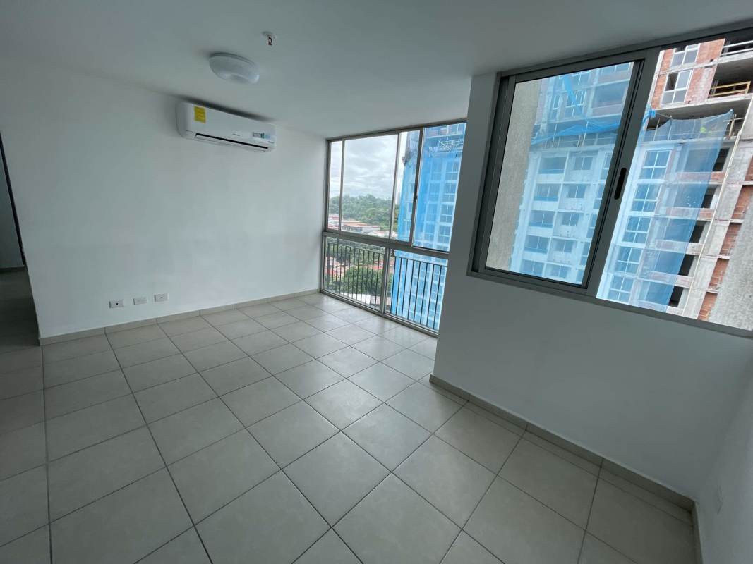 Living area with large windows and balcony in PH Alsacia apartment Condado del Rey Panama