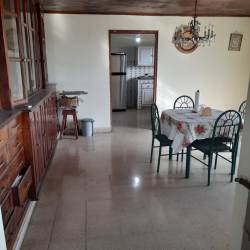 Bright kitchen with wood ceiling white cabinets refrigerator Interamerican Highway property