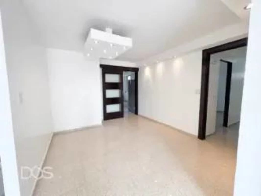 Empty modern living room with polished floors and glass door PH Marbella Tower Panama City