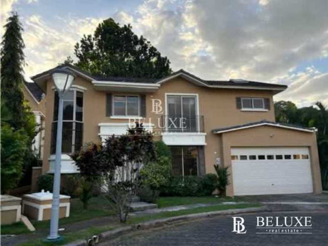 Two-story beige house with garage balcony garden Embassy Gardens Clayton Panama