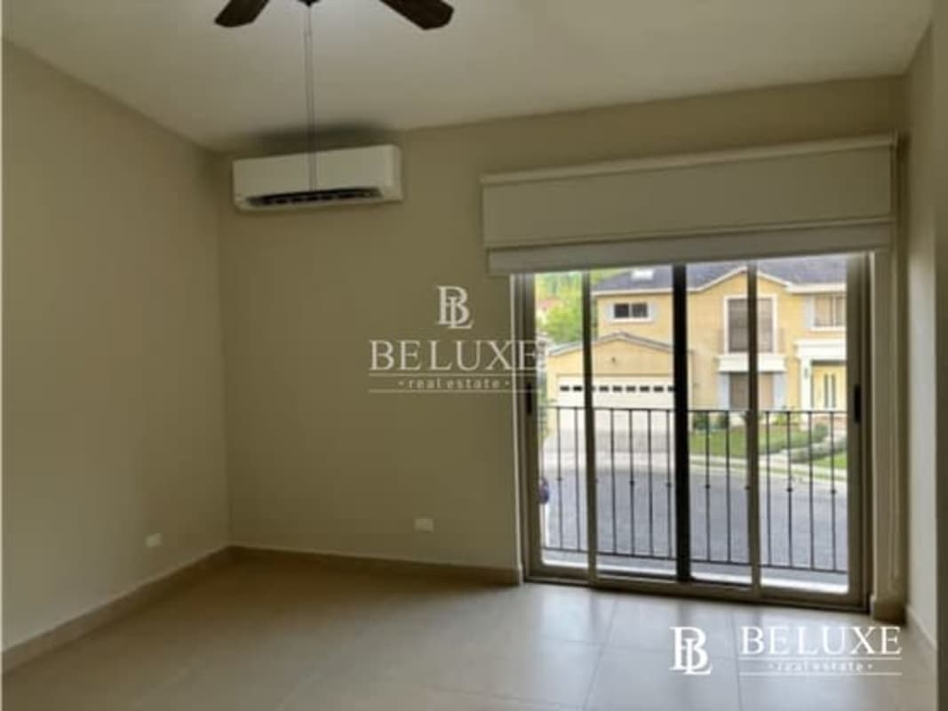 Kitchen with granite island countertops wood cabinets in Embassy Gardens Clayton Panama