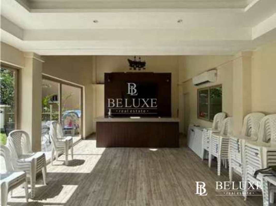 Multipurpose hall with stacked chairs sliding glass doors Embassy Gardens Panama