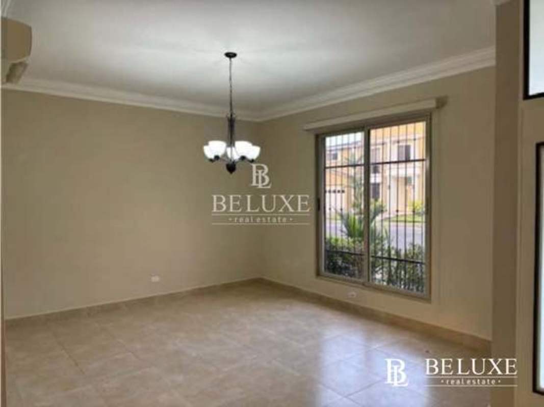 Bright living room with large windows and ceiling fan Embassy Gardens Clayton Panama