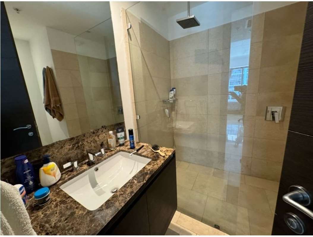 Modern bathroom marble countertop and glass shower at JW Marriott Panama The Ocean Club condo