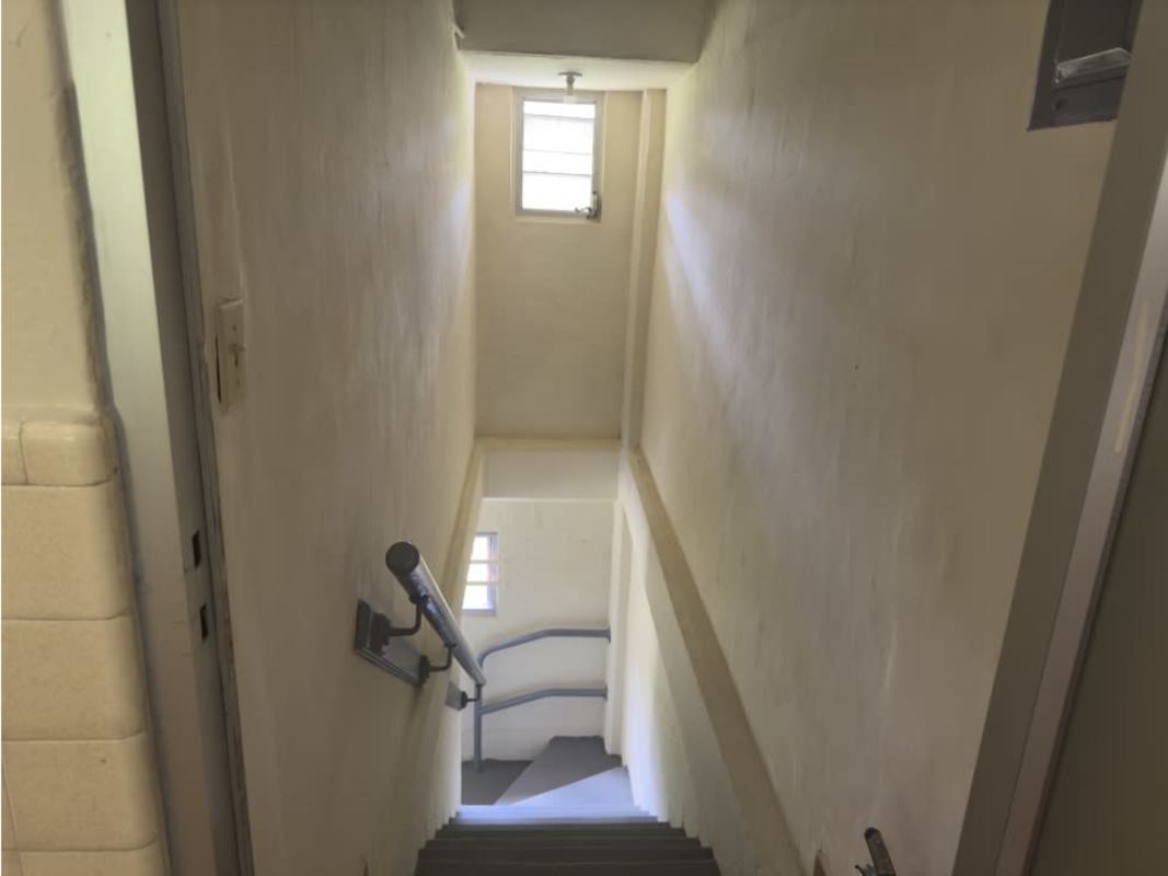 Bright living area with ceramic tile floor and stairs in Clayton Panama home