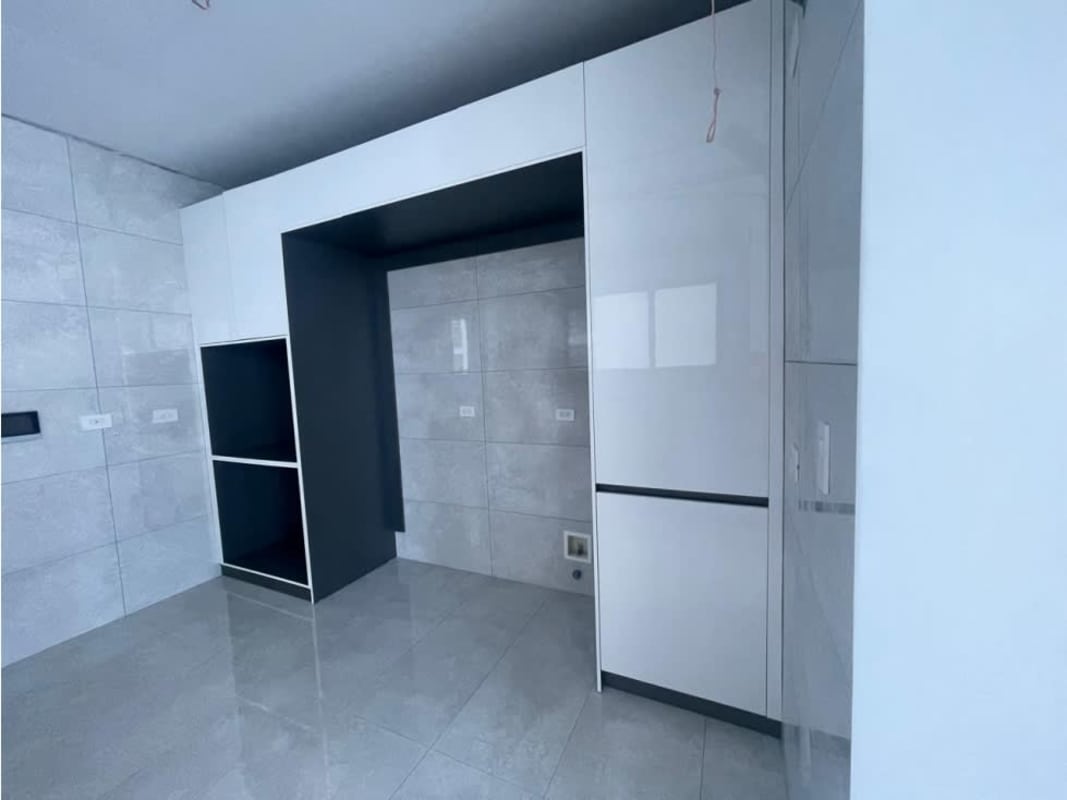 Unfinished modern kitchen space with grey tile and cabinetry PH Ocean Front