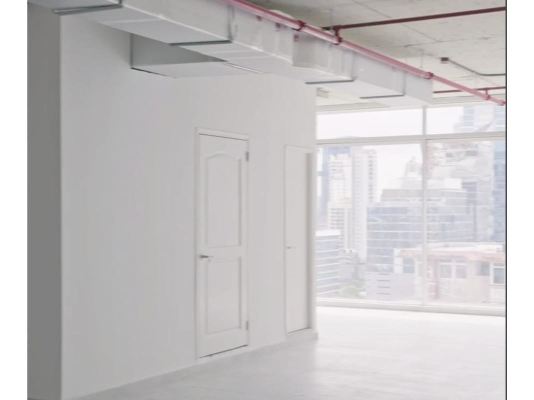 Unfurnished modern office with large city-facing windows and exposed ceiling for lease in PH Sortis Tower Obarrio Panama
