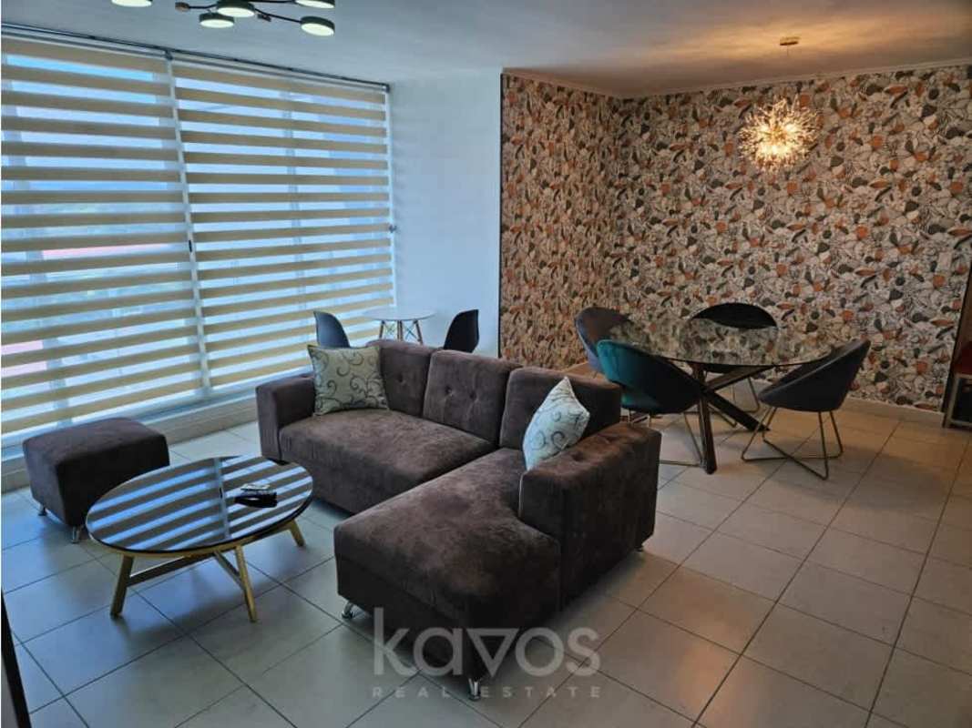 Open living and dining area with large windows, modern decor in PH Miró El Cangrejo Panama City