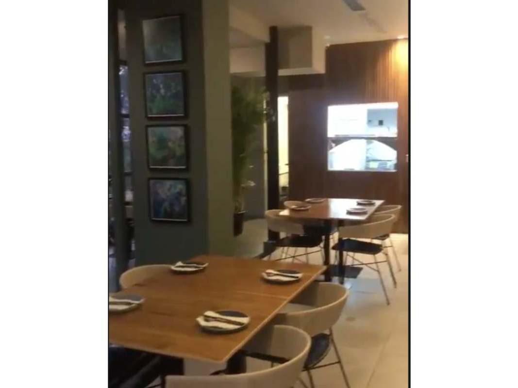 Contemporary dining area with natural light, wood tables, large windows Obarrio district Panama