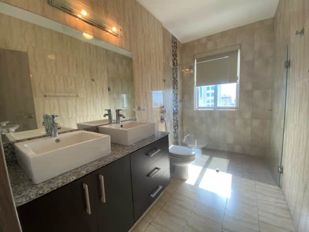 Bathroom with granite vanity, glass-enclosed shower at PH Premium San Francisco Panama