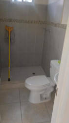 Compact modern kitchen with granite counter and tile backsplash new rental house Bosque Dorado La Chorrera