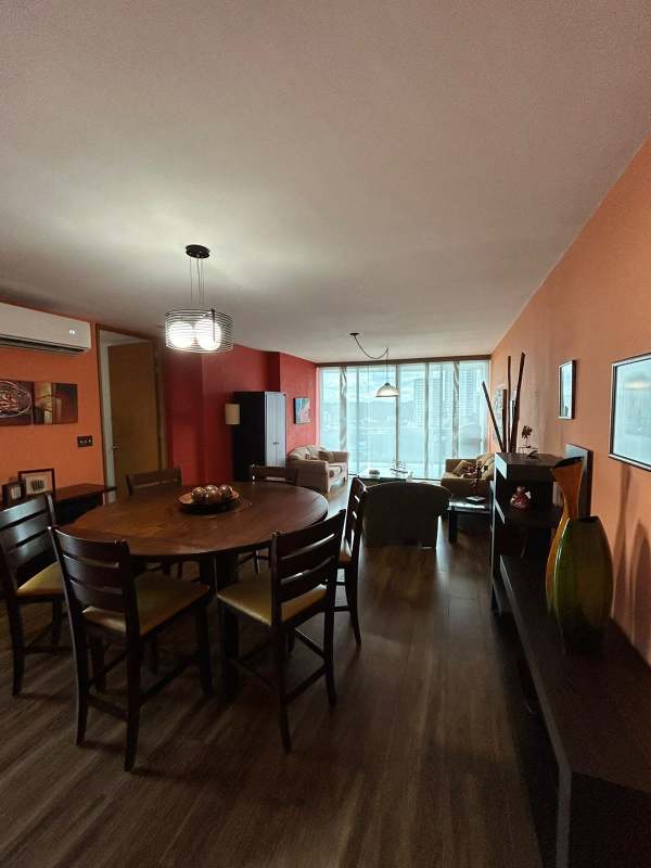 Remodeled kitchen with wood cabinetry, granite countertops, gas stove, and large window PH Mont Royale El Cangrejo Panama