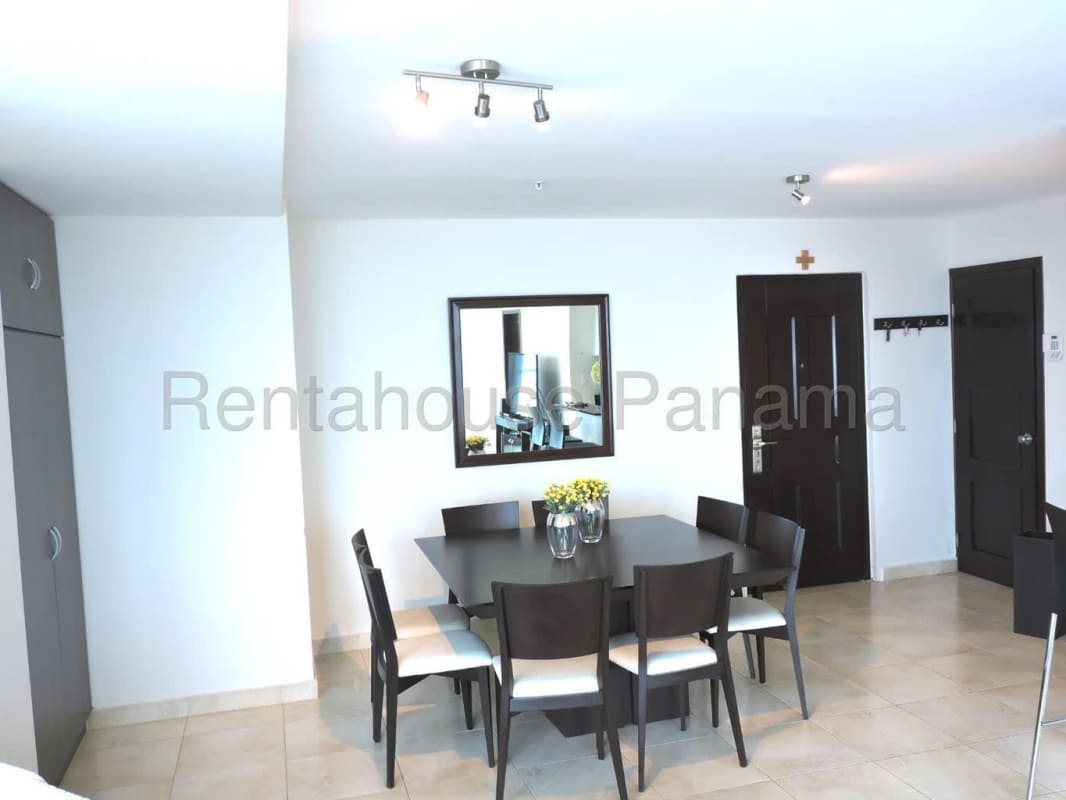 Dining area adjacent to open kitchen with porcelain floors at PH Costanera Costa del Este Panama City
