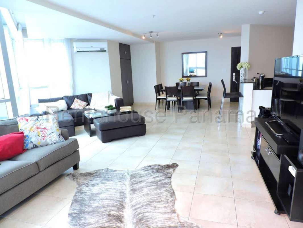 Open plan living dining with large windows and Pacific ocean view at PH Costanera Costa del Este Panama