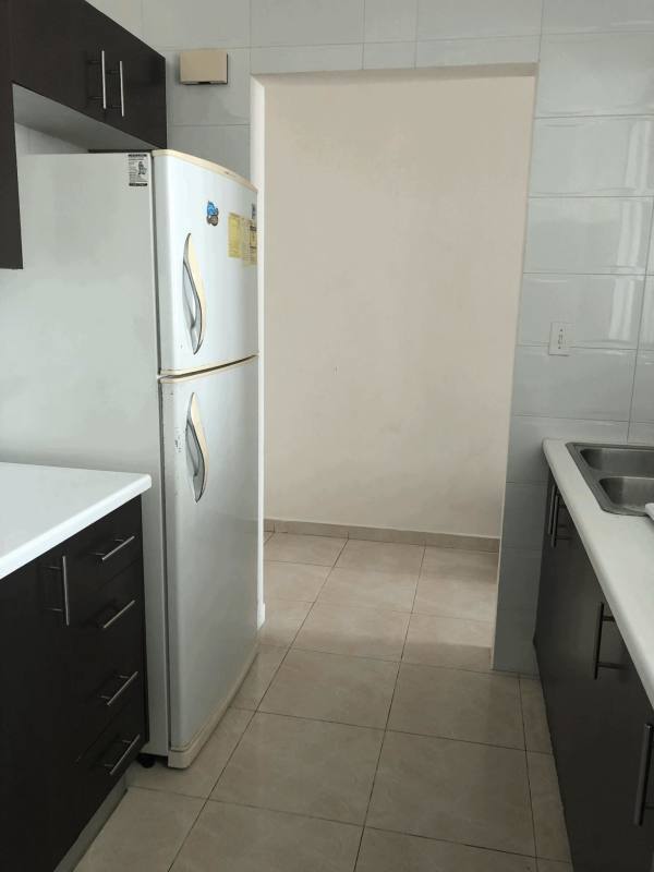 Modern bathroom with glass-enclosed shower, pedestal sink in Vivendi Towers Panama City