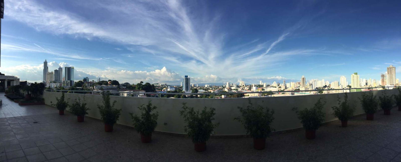 Compact kitchen with upper and lower cabinets and ceramic backsplash at PH Vivendi Towers Edison Park
