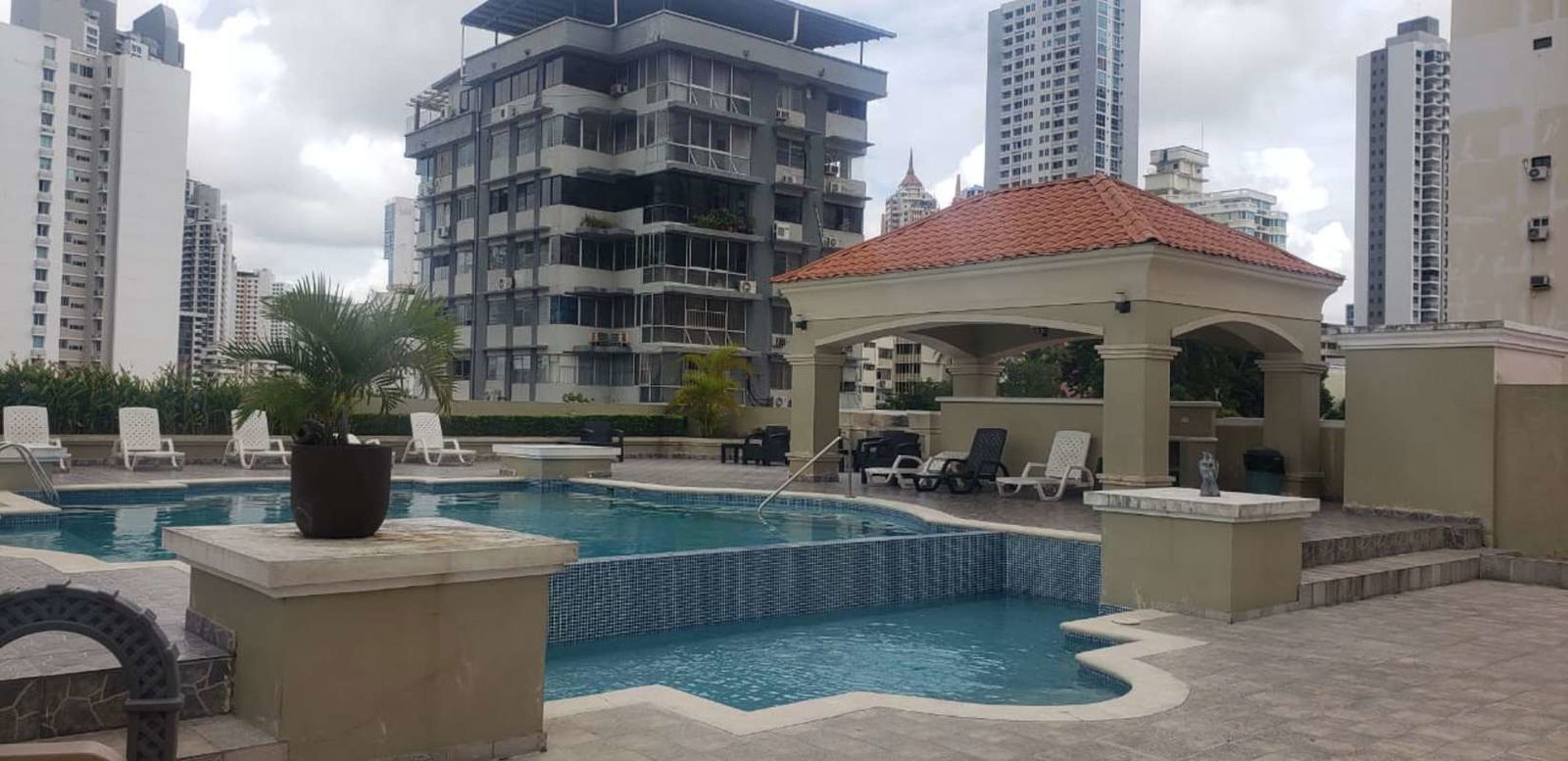 Outdoor pool with lounge chairs at PH El Cangrejo in Panama City