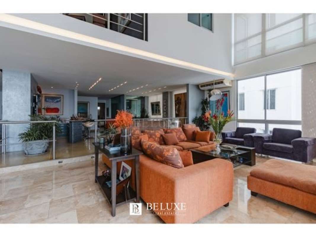Private penthouse family room with large windows, natural light, ocean city views at PH Premier Loft Panama