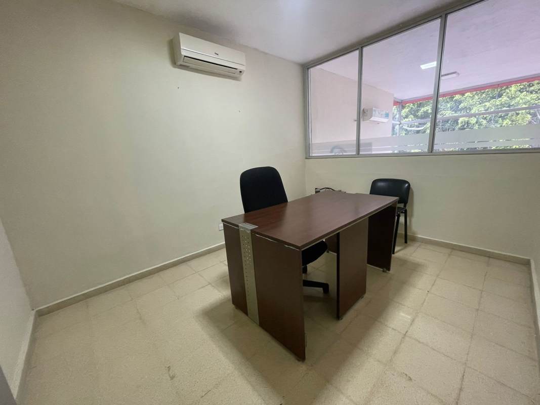 Small minimalist office with tile floor desk chairs large window air conditioning