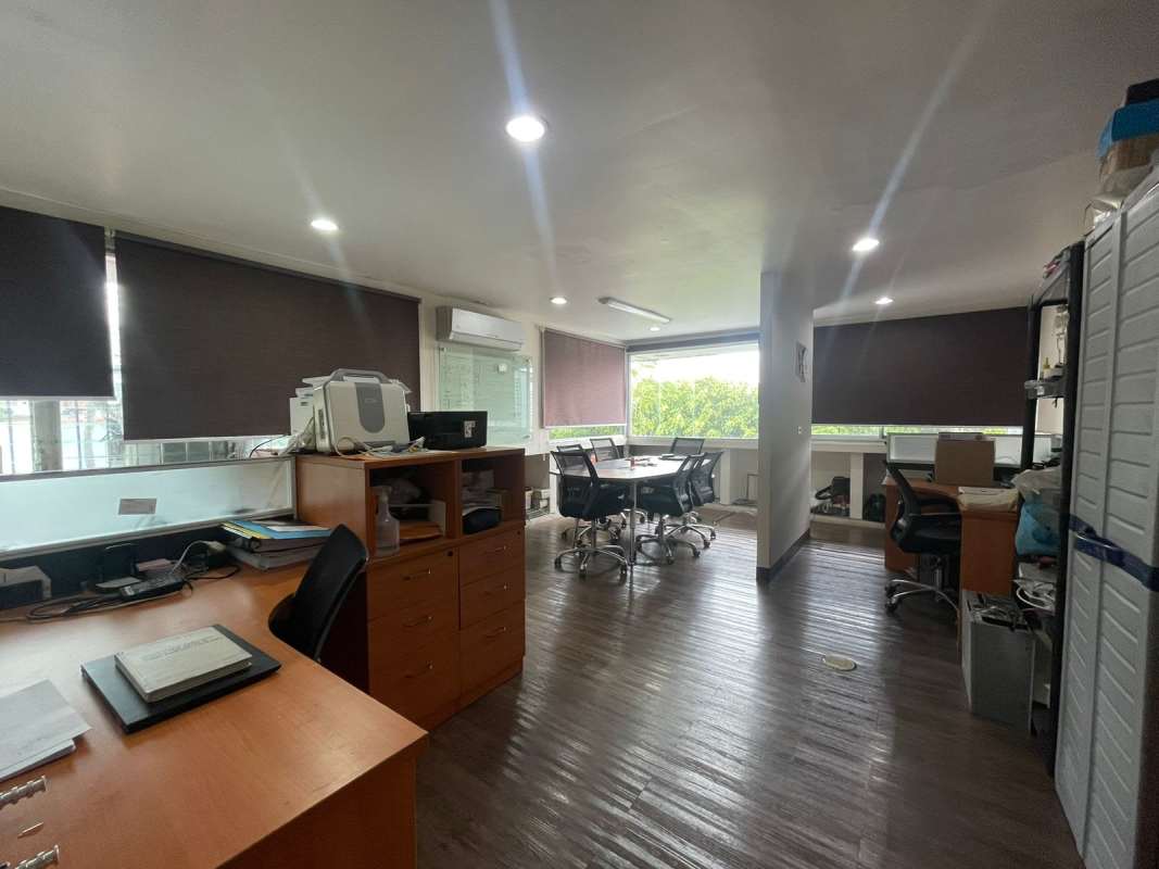 Modern bright office with large windows blinds tiled floors air conditioning