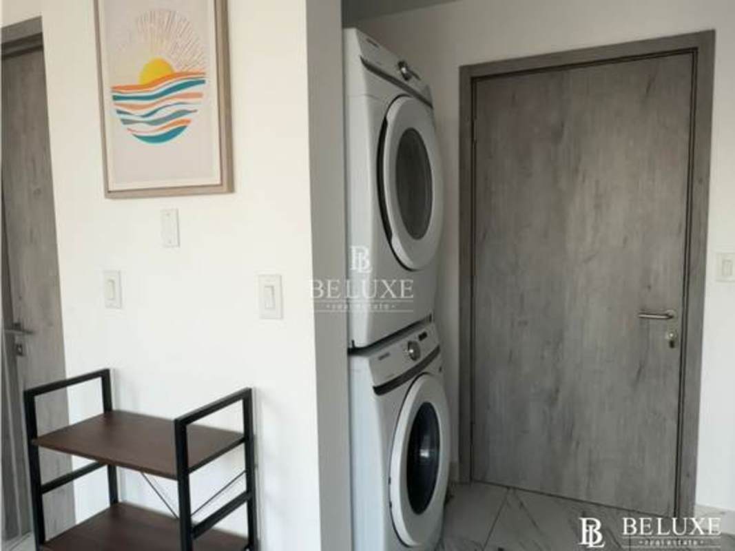 Compact modern kitchen in furnished apartment PH The Gray with granite counters, appliances, and tile floor Panama