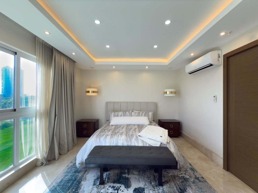 Luxury bedroom with panoramic golf view and large windows in Santa María Panama