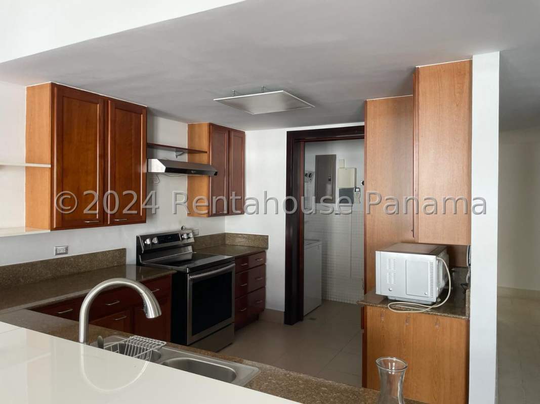 Restored colonial living room with stone wall, balcony, tile floor, ceiling fan in Casco Viejo San Felipe Panama