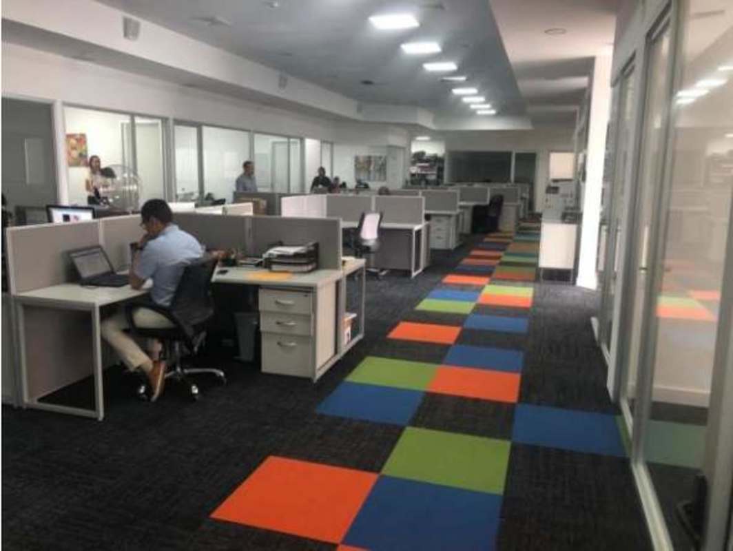 Modern corporate office with glass enclosed meeting and open workspaces Plaza Costa Sur Panama