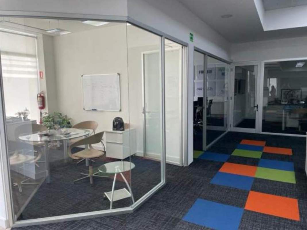 Interior meeting space with glass partitions modern furniture Plaza Costa Sur Panama City