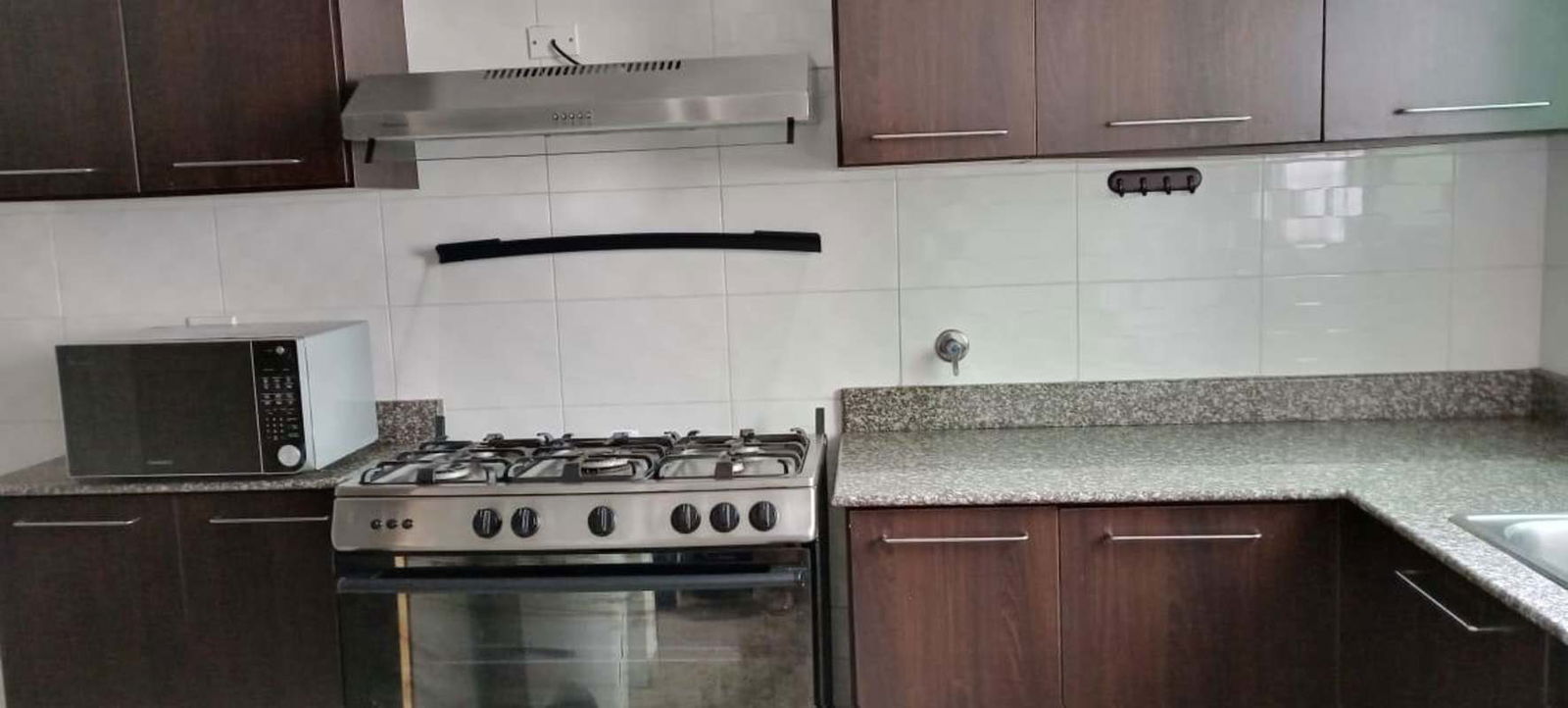 Contemporary kitchen with granite, gas stove, cabinetry PH Belle View Panama City