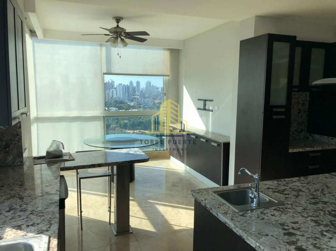 Modern granite kitchen with dining space overlooking city at PH Puntarenas Panama