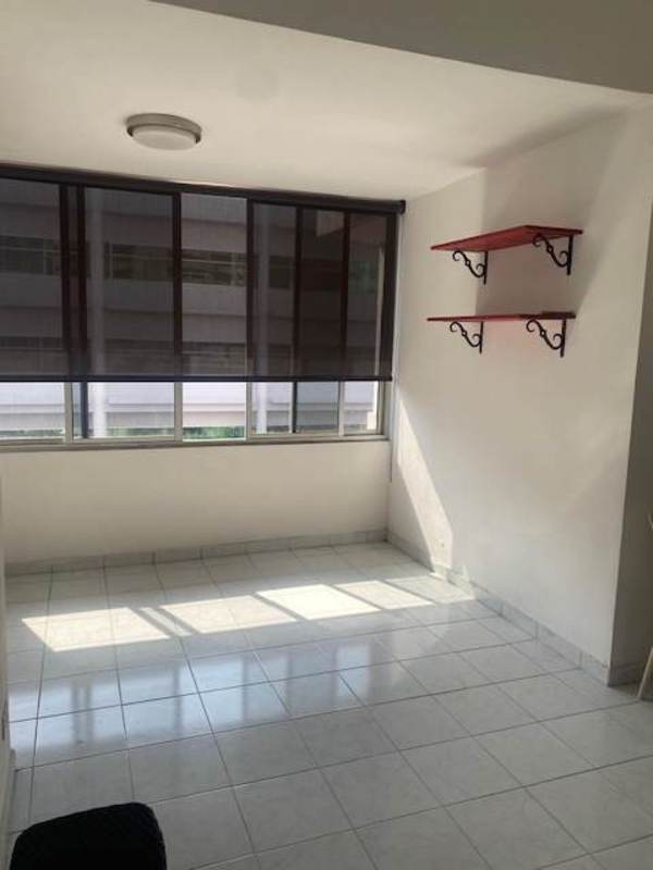 Living area with large window, roller blinds, ceramic tile floor in PH Brisas del Sur apartment