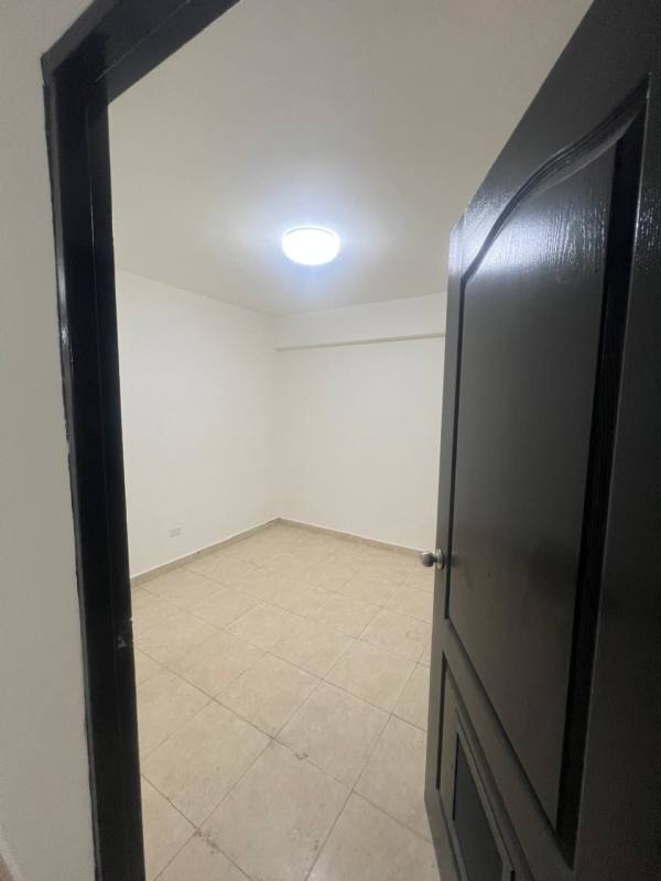 Empty bedroom with tile floor and natural light window in Río Abajo Panama